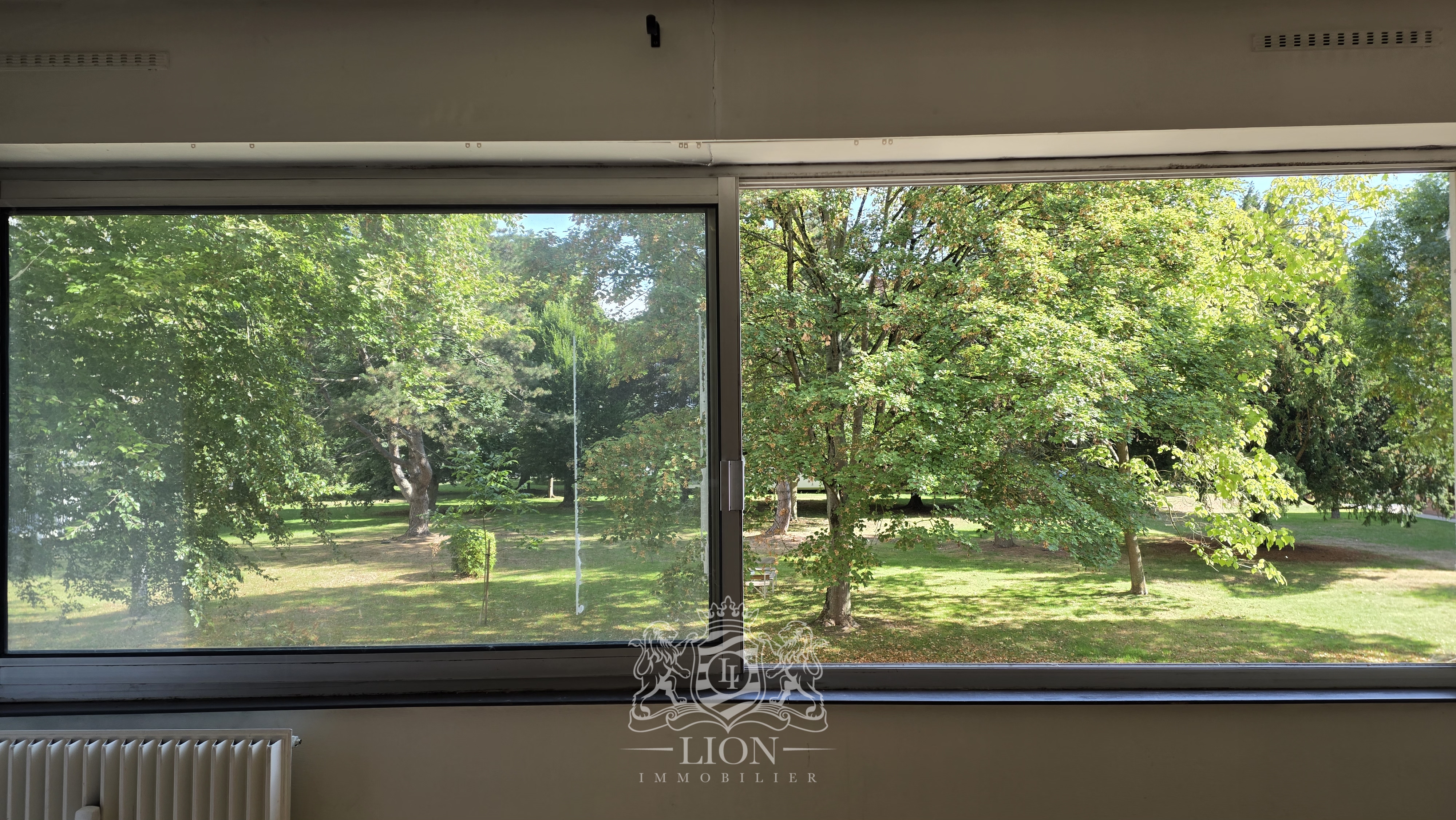Appartement t2 vue verdoyante avec garage   parking Photo 1 - Le Lion Immobilier